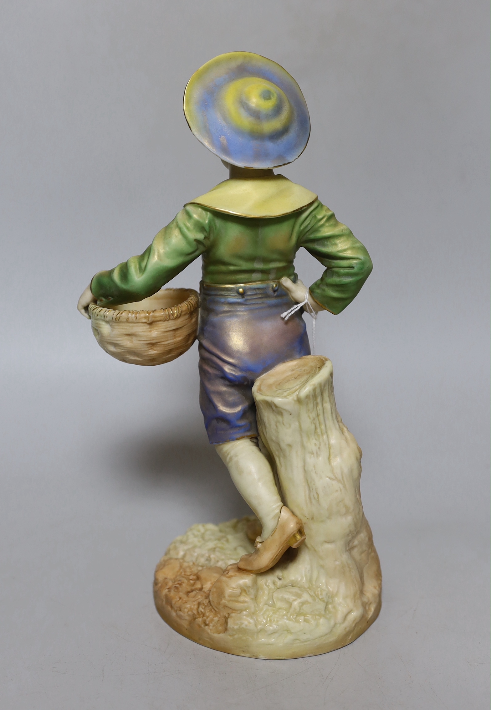 A Royal Worcester figure of a boy with a basket and a broad brimmed hat painted in shot enamels shape 1388, date mark 1895, 28cm high